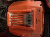 an orange electric driller sitting on top of a table
