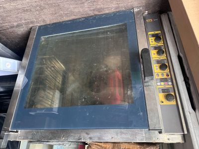 a small oven sitting on top of a table next to a box