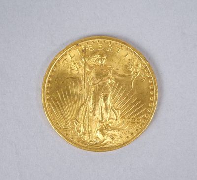 gros plan d'une pièce d'or sur une surface blanche