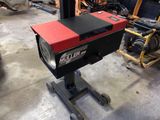 a machine that is sitting on a stand in a garage