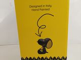 the box is open to show the peanuts snoop figurine