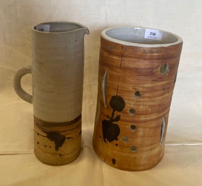 two vases sitting next to each other on a table
