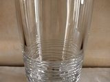 a clear glass with a sticker on it sitting on a table