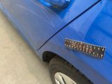 a blue car with a ruler on the side of it