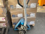 a dolly that is sitting in front of a stack of boxes