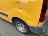 a yellow van that is parked in a parking lot