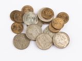 a pile of old coins on a white surface