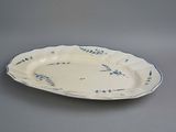 an oval platter with blue and white floral designs on it