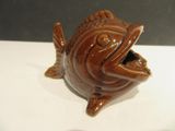a small ceramic fish that is sitting on a table