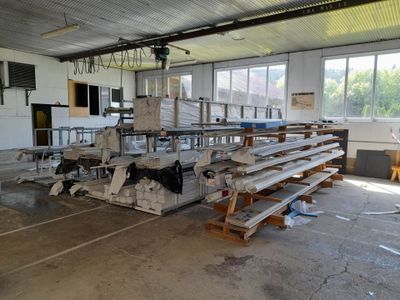 a room with a lot of tables and benches in it