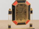 a small clock that is sitting on a table