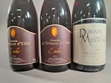 three bottles of wine sitting on a table next to each other