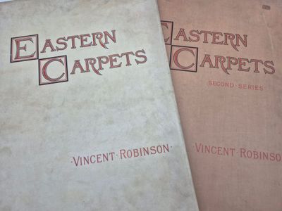 two books sitting on top of a table next to each other