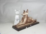two figurines of a dog and a cat sitting on a table