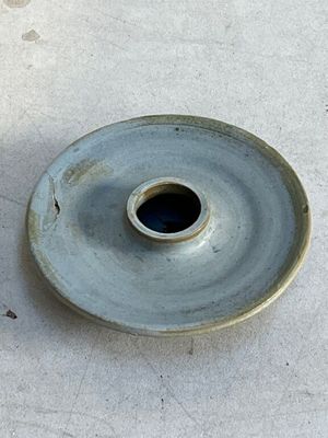 a blue plate with a hole in the middle of it