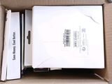 a box with a laptop inside of it sitting on the floor