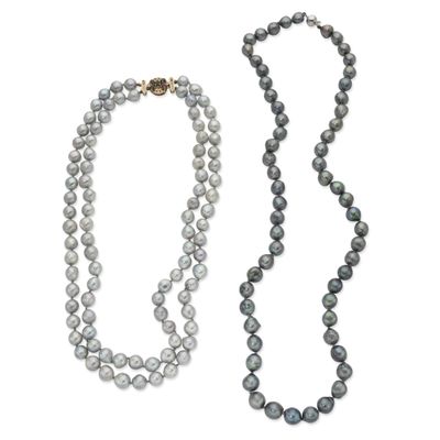 a close up of a strand of pearls with a gold clasp