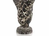 a black and white vase sitting on a white surface