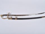 two swords with gold and black handles on a white surface