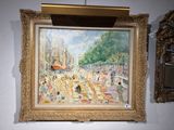 a painting hanging on the wall next to a mirror