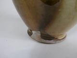 a brown vase sitting on top of a white table