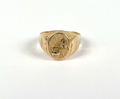 a close up of a gold ring with a man ' s face on it