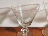 two empty wine glasses sitting on a wooden table
