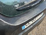 a close up of a black car with a license plate on it