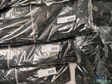 a pile of black plastic bags sitting on top of each other