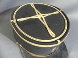 a black hat with a gold cross on top of it