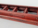 a red wooden box with six compartments on it