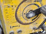 a machine that is sitting on the ground next to a pile of junk