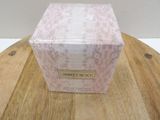 the box is sitting on a wooden table with a white wall in the background
