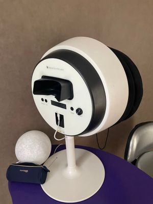 a white and black clock on a table with a golf ball