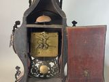 a clock that is sitting on a table with a door open
