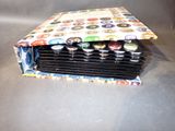 a stack of beer bottle caps sitting inside of a bag