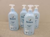four bottles of biolane baby lotion sitting on a table