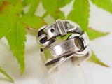 a close up of a silver ring on a rock