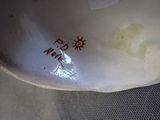 a close up of a white vase with writing on it