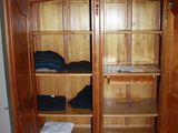 an image of a large wooden cabinet in the corner of a room