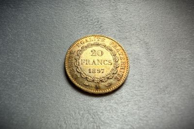 a close up of a coin on a table with a black background