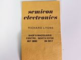 a yellow business card on a white surface