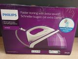 packaging of a philips steam iron sitting on a wooden table