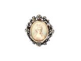 a close up of a ring with a picture of a woman on it