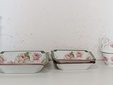 a white table with a bunch of dishes and cups on it