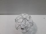 a small white object on a table with a white background