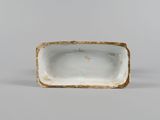 an image of a white and gold plate on a white surface