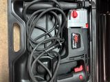 a black box with a cord in it on the floor