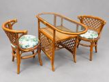 three chairs and a table with a glass top
