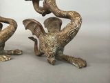 two metal birds that are sitting on a table